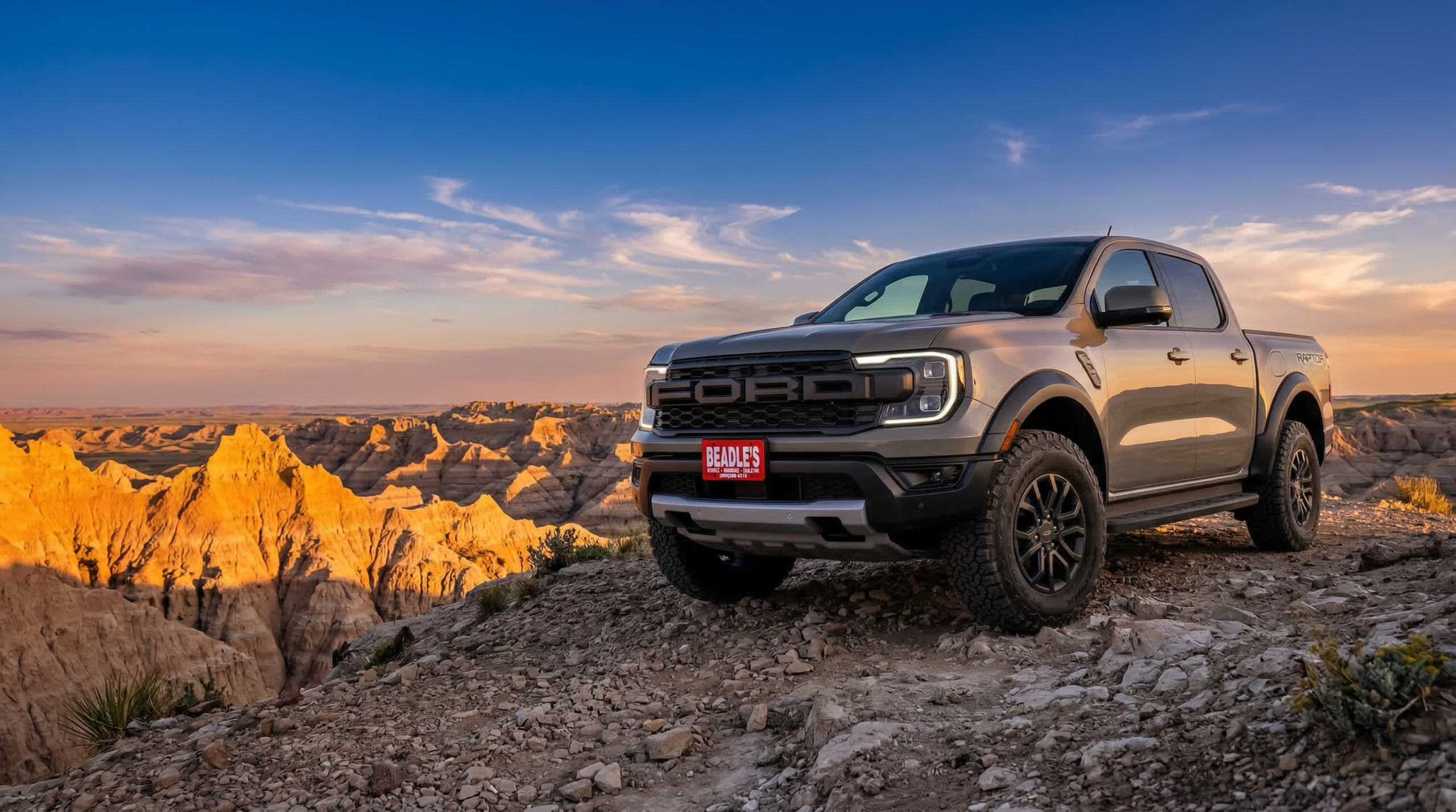 2026 Ford Ranger Raptor parked on a Badlands overlook in South Dakota at sunset